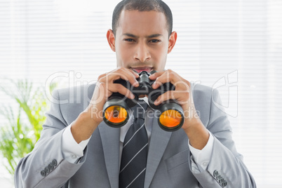 Portrait of a confident businessman with binoculars Portrait of a confident businessman with binoculars