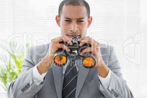 Portrait of a confident businessman with binoculars