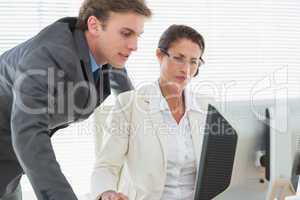 Smartly dressed business couple using computer