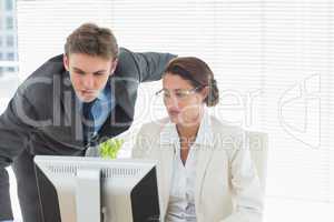 Smartly dressed business couple using computer