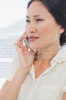 Beautiful young businesswoman using cellphone