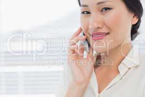 Beautiful young businesswoman using cellphone