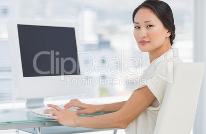 Young businesswoman using computer in office