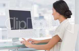 Young businesswoman using computer in office