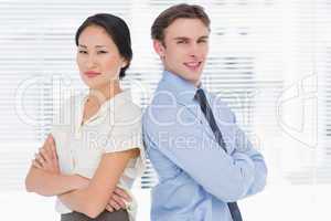 Business colleagues standing with arms crossed