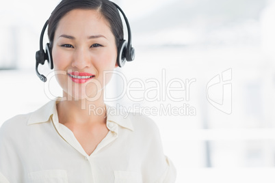 Beautiful smiling female executive with headset