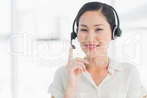 Beautiful smiling female executive with headset