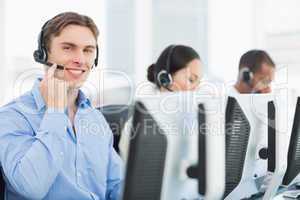 Business colleagues with headsets using computers