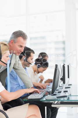 Manager and executives with headsets using computers