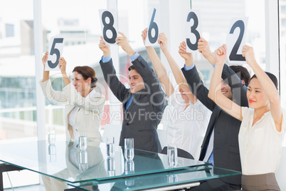 Judges in a row holding score signs