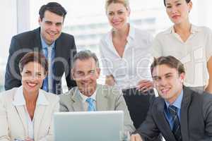 Business colleagues with laptop at office desk