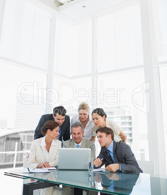 Business colleagues with laptop at desk