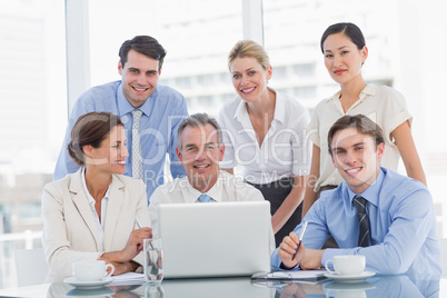 Business colleagues with laptop at desk