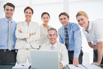 Business colleagues with laptop at desk