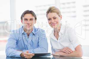 Smiling businessman and woman at office