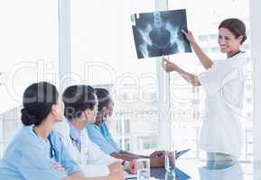 Doctor explaining x-ray to her team during a meeting