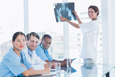 Female doctor explaining x-ray to her team