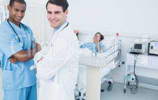 Portrait of smiling doctors with patient at hospital