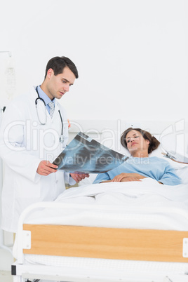 Doctor showing x-ray to female patient