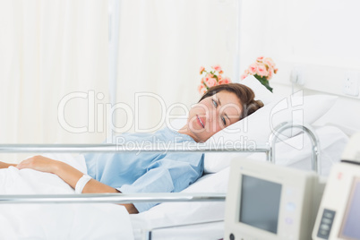 Female patient lying in medical bed