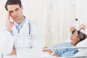 Worried doctor with patient in hospital