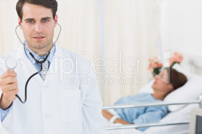 Handsome doctor with patient in hospital