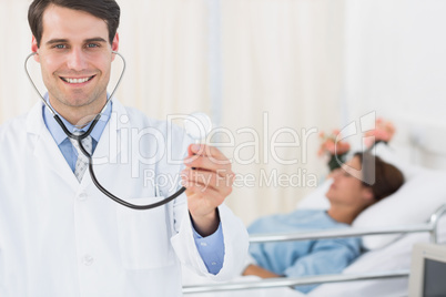 Handsome doctor with patient in hospital