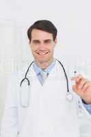 Handsome male doctor holding an injection