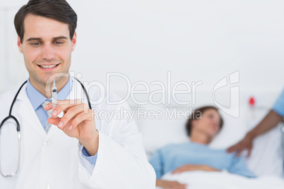 Male doctor holding an injection in the hospital