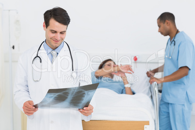 Doctor examining x-ray with patient in hospital