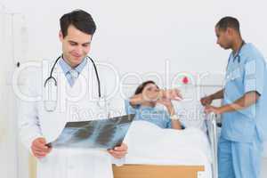Doctor examining x-ray with patient in hospital