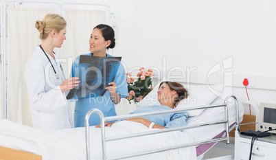 Doctors examining x-ray with patient in hospital