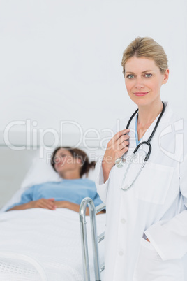 Smiling doctor with patient in hospital