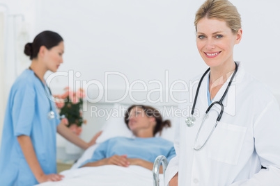 Smiling doctor with patient in hospital