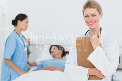 Smiling doctor with patient in hospital