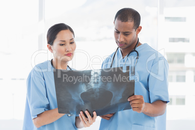 Two surgeons examining x-ray