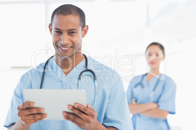 Handsome male doctor holding digital tablet