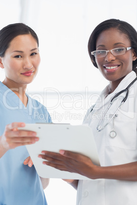 Female doctor and surgeon with report