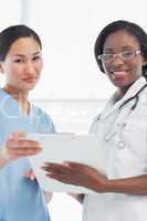 Female doctor and surgeon with report