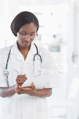 Female doctor writing report