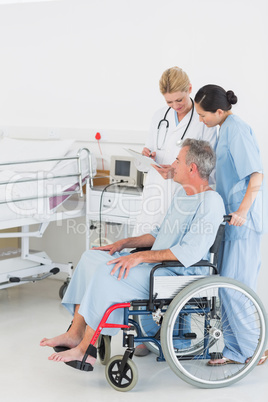 Doctor talking to a patient in wheelchair at hospital