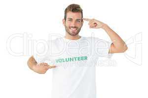 Portrait of a happy male volunteer pointing to himself