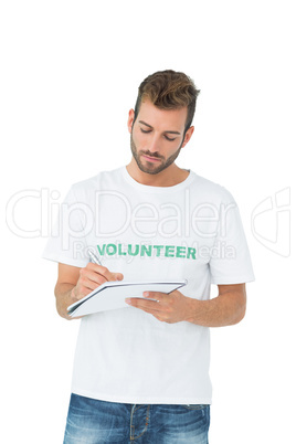 Young male volunteer writing a note