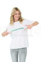 Portrait of a happy female volunteer pointing to herself