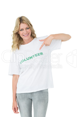 Portrait of a happy female volunteer pointing to herself