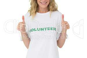 Mid section of a happy female volunteer gesturing thumbs up