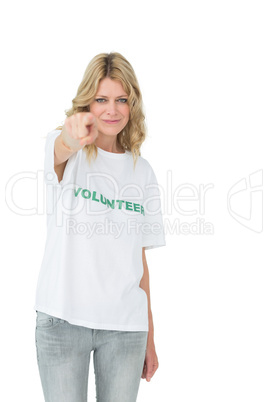 Portrait of a happy female volunteer pointing at you