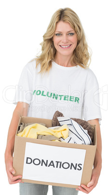 Portrait of a smiling young woman with clothes donation