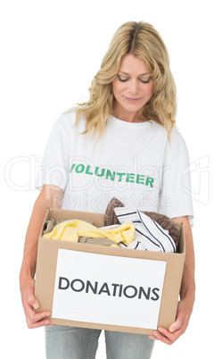 Smiling young woman carrying clothes donation