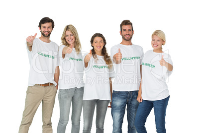 Group portrait of happy volunteers gesturing thumbs up